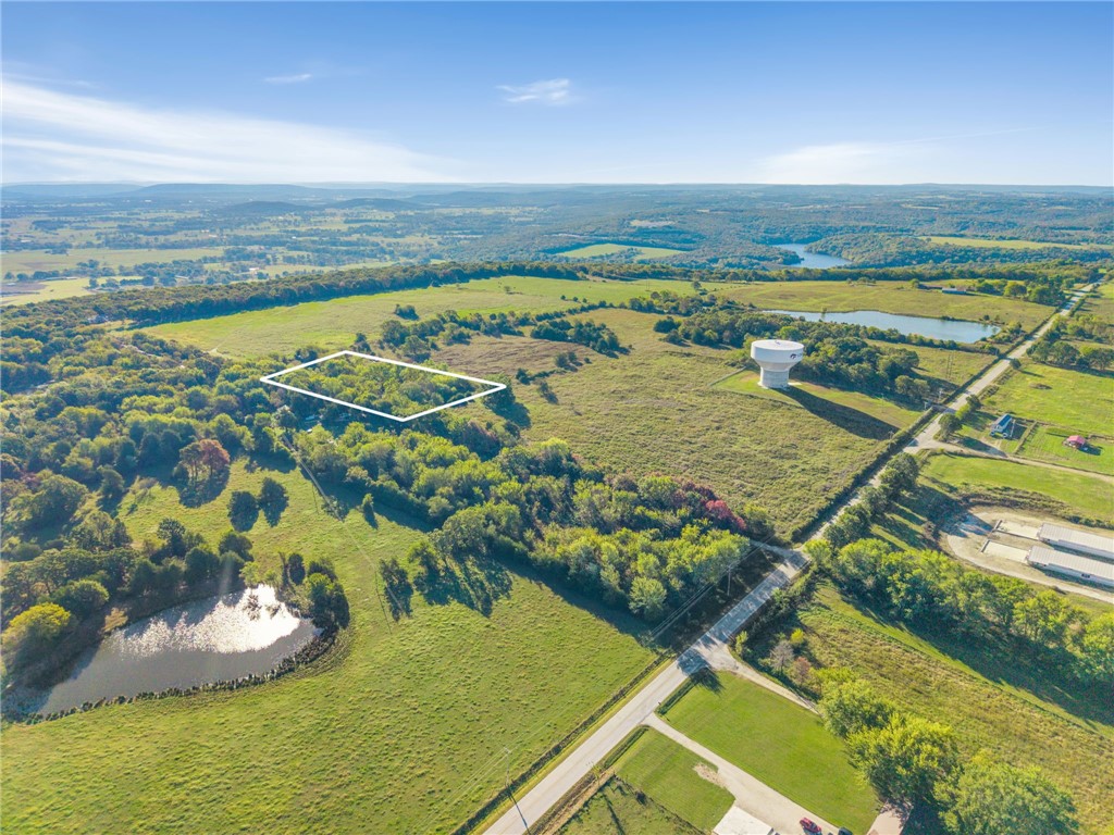 3.87 Acres with Charming 2 BR/1 BA home with barn & outbuildings! - Discover a rare blend of history, beauty, and functionality on this 3.67-Acre property. The property includes a 1008 sq ft. 1914 farmhouse with 2 bedrooms & 1 bath ā full of character and good bones, ready for restoration or a weekend retreat. Several outbuildings add to the charm and functionality, including a historic log smokehouse, perfect for those who appreciate heritage and craftsmanship. Perfect for the handyman. Shaded by century-old oak trees and mature hardwoods, the property offers peaceful seclusion. Enjoy privacy and convenience, just 10 minutes to Lincoln schools, shopping, gas, and dining; 20 minutes to Siloam Springs or historic Prairie Grove, and only 30 minutes to the University of Arkansas. Whether you're seeking a private getaway or a piece of local history to make your own ā this remarkable property offers it all. More land is available for purchase if desired. Also See MLS# 1326116, 1326221, 1326228, 1326237, 1326252