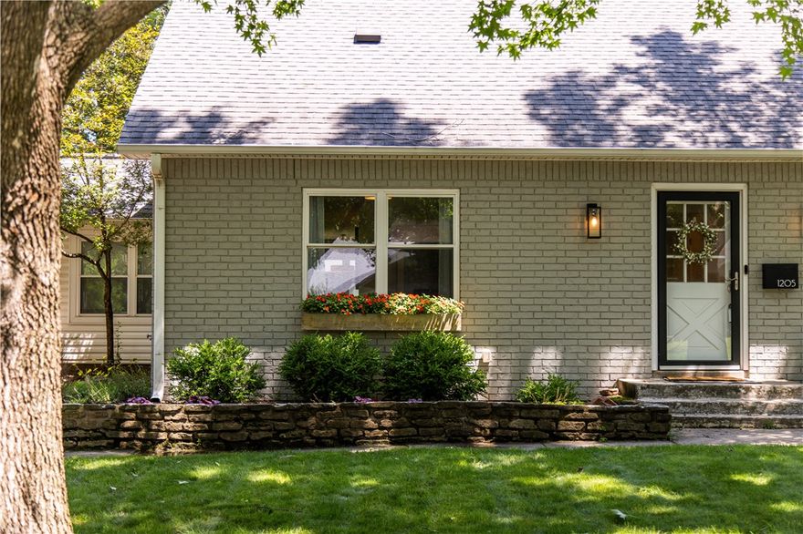 Welcome to this charming 4-bedroom, 2.5-bath home offering an unbeatable location to the Square, Crystal Bridges, Orchards Park, the Momentary, and top-rated schools—with easy access to I-49 and trails. Situated on a shady lot with mature trees, window boxes, and a backyard shed, this 2-story home combines timeless curb appeal with modern updates. The open floor plan centers around a custom kitchen featuring quartz counters, double wall ovens, a gas range with hood, and island seating. On the main level, a formal dining room, breakfast nook, home office/guest room, and a front sitting room provide versatile living spaces. An extensive renovation and expansion in 2017 included a spacious primary suite with a sleek bath and walk-in shower, while a mudroom with custom pegboard adds storage space. Recent improvements include a new roof, new garage doors, an updated HVAC system, and a mini split. A rare find in the heart of Bentonville, this home delivers style, thoughtful updates, and an excellent location all in one.