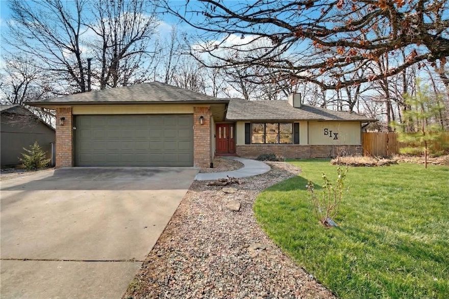 Welcome to this private, single level home built by a popular builder in a great location! Right down the street is Branchwood Rec Center, featuring a gym, tennis, pickleball, disc golf, walking trail, playground, and more! You'll be less than 5 minutes from I-49, Highlands Golf Course & Pub, Loch Lomond lake, and a dog park. The home offers 3 beds, 2 full baths, and a large sunroom overlooking the serene wooded backyard. The back is loaded with entertainment space, featuring ample deck spaces on each side of the enclosed sunroom, and a hot tub to boot. Inside you will find hard-surface floors throughout except 1 bedroom with carpet. The massive primary shower was remodeled with onyx stone surround, glass doors and easy accessibility. The huge living room features tall ceilings and a wood burning fireplace. Roof, fence, and deck were all replaced in 2022. Fridge/washer/dryer may convey with acceptable offer. Home warranty included! 2 Additional lots behind home may be purchased as well! Contact agent for pricing.