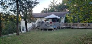 Unique, rare and one of a kind is just some of the ways to describe this property. 15 acres with the home overlooking a waterfall. Peaceful and private where wildlife abounds. 2 story home that 3 bedrooms, 1 bathroom, wood burning fireplace and deck. The downstairs that is completely separate from the main living area offers a kitchen, bathroom, living room and a built in murphy bed. There is a wonderful enclosed gazebo that overlooks the waterfall. Lots of decks to enjoy the outside space. 3 car detached garage and a storage building that could be used for a man cave. 40 x 60 barn that has loads of possibilities.