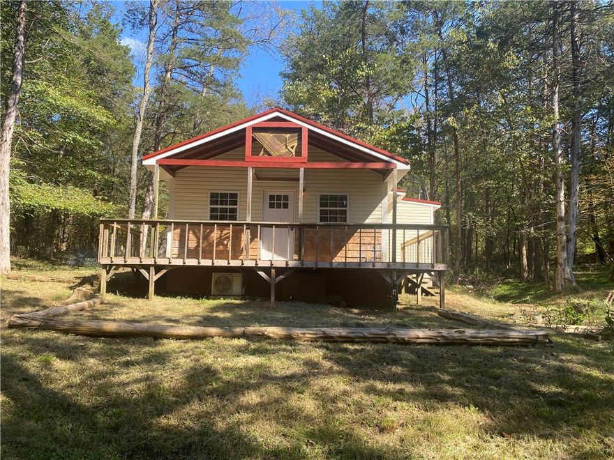 Enjoy the peaceful rural surroundings from the front porch of this cozy 2 bedroom, 1 bath country cabin on 1.36 acres, more or less.  Recently remodeled with vinyl plank floors and ceramic tile in the bathroom, new cabinets and butcher block countertop.  There is a spacious bathroom with a walk-in shower and stacked washer dryer combo that will convey with purchase. The cabin is 575 sq ft of heated floor space with large front and corner deck.  Property is just minutes from Huntsville.  This one is definitely priced right!