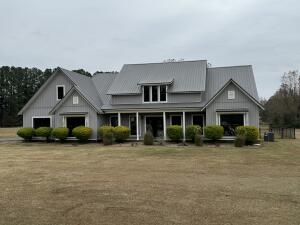 Welcome to your dream property! Sitting on 6.83 acres with stocked pond, this expansive 2,880 square foot home offers the perfect blend of modern convenience and serene countryside living. With 3 spacious bedrooms & 2.5 baths, this residence provides ample room for family and guests. Step inside to discover an inviting open floor plan that seamlessly connects the living areas. The elegant kitchen is equipped with modern appliances and plenty of counter space. The bright and airy living room is an ideal spot for relaxation or entertainment, while the convenient office/game room offers flexibility for work, hobbies, or family game nights. Outside, indulge in a private oasis featuring an in-ground pool and a luxurious hot tub. Also included is a 35 x 50 shop, fully heated and cooled.