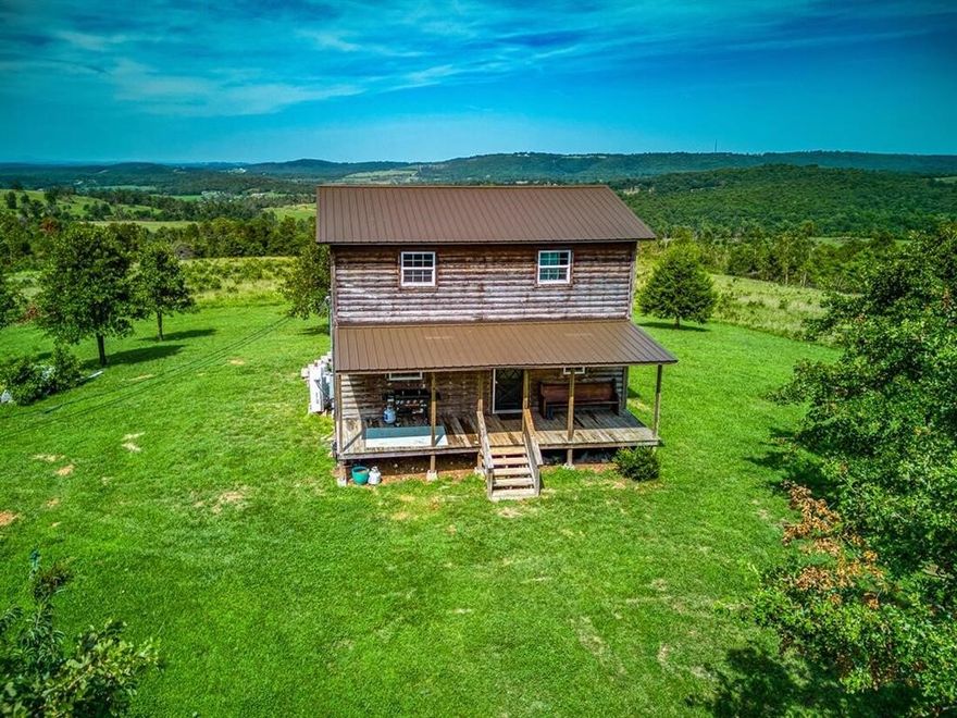 Welcome to paradise! Tucked away in the rolling Ozark hills lies this beautiful rustic, hobby farm with 21.8 m/l acres of land with no restrictions, a pond, sunrise and sunset views that will take your breath away, peach and pear trees, a back to Eden Garden, its own private well and offers a perfect blend of natural beauty and rural charm. The home, built in 2012, features 3 bedrooms and 2 full bathrooms. On the main level, you will find a covered front porch for sunrise views, a covered back deck (2 of them) for sunset views, a beautifully updated kitchen with butcher block countertops, a gas range and black stainless appliances, living room with a gas fireplace and dining space all complete with new LVT flooring!