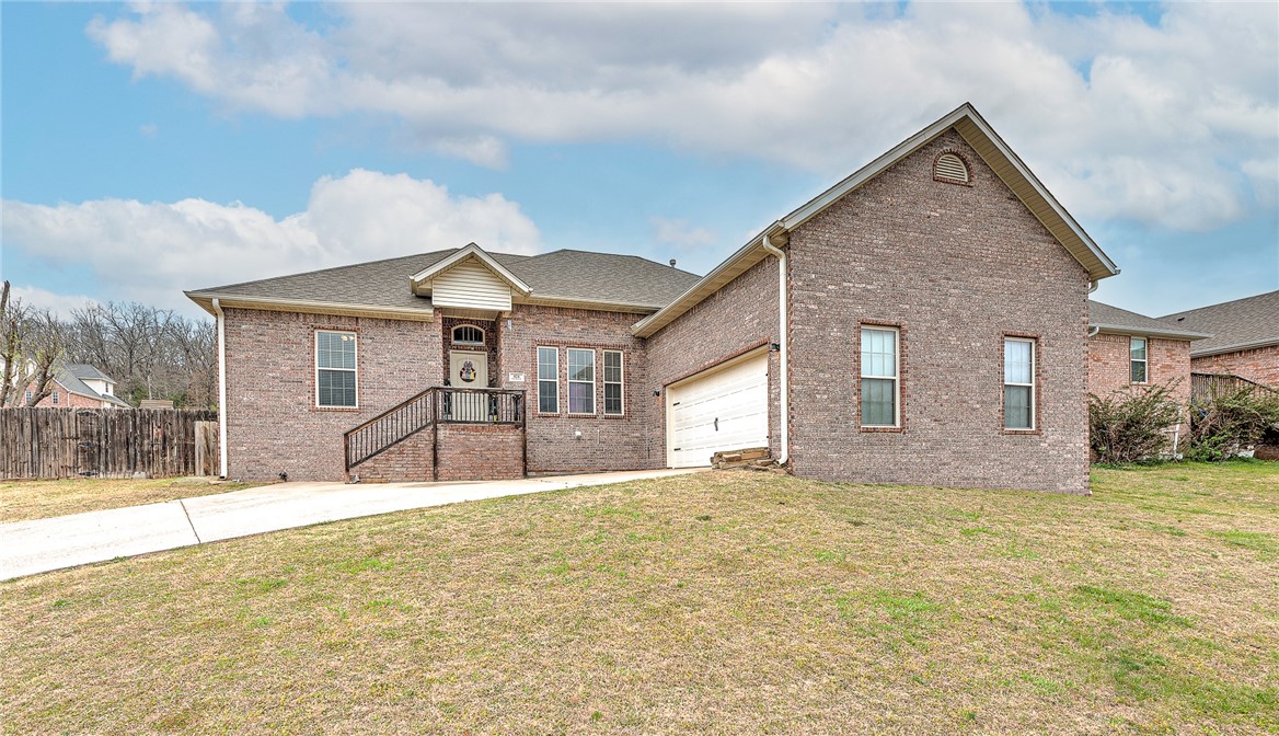 Come see this charming traditional all-brick home, conveniently located one mile from I-49 and 9 minutes from the University of Arkansas! This inviting home features three spacious bedrooms, two full baths, and a versatile bonus room with a large storage closet—perfect for a home office, playroom, or hobby space. Additional highlights include hardwood floors, 10-ft ceilings, newer matching GE stainless steel appliances in the kitchen, and a spacious primary bathroom with his-and-hers sinks and separate closets. A large fenced-in backyard is perfect for pets and a stamped concrete patio is ideal for weekend barbecues or your morning coffee. The garage offers plenty of storage space and potential with a 13 ft ceiling and room for two cars.