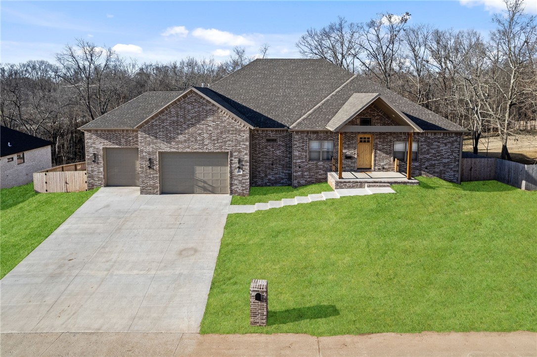 Looking for your forever home conveniently located in Rogers, close to the city, with an out-of-town feel? 4 Beds, 3.5 baths, an Office, a Huge Bonus Room, a Man Cave, and a Movie Room! Custom White Oak soft-close cabinets throughout, Custom JennAir built-in Fridge and freezer with White Oak, and vaulted Living Kitchen & Dining Rooms. A 10X5 Kitchen Island with Quartz Counters, white oak built-ins, a primary suite with a fireplace, dual rain shower heads, a 6X4 custom jacuzzi, two-story 700+ sf covered back patios with composite decking, and plenty of shade—a fully fenced-in backyard with Cedar and Metal fencing on 1.1 acres. The oversized insulated 3-car garage has 10' tall doors and 15'4 height, fiber optic internet, and a gas stovetop.