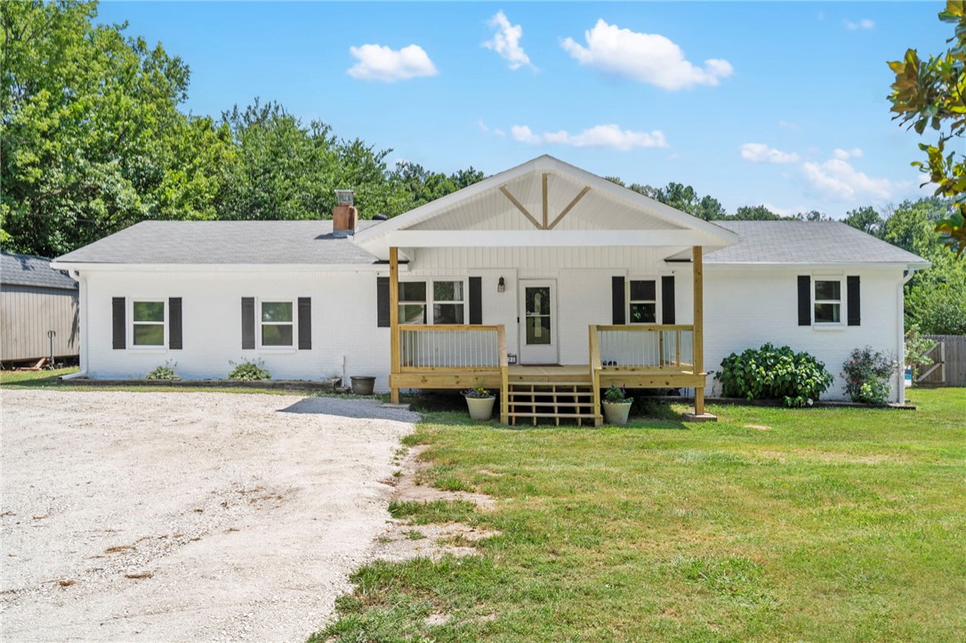Charming country oasis just minutes from town. Welcome to your new home where peaceful rural living meets modern comforts. This beautifully updated 5 bed, 2 bath home sits on nearly 5 acres of lush usable land. Direct creek access perfect for swimming, kayaking or fishing right in your own backyard. Just 20 minutes to the University of Arkansas and 15 minutes to I49. You are close enough to town for convenience, yet far enough away to enjoy the tranquility of country life. Step onto your brand new covered front porch, or unwind on the covered back deck overlooking the pool and mature fruit trees. Inside, enjoy new flooring throughout, gorgeous pine ceilings, a cozy wood-burning stove and an oversized kitchen with a double oven and abundant storage, a true dream for home cooks and entertainers alike. With a chicken coop ready for your hobby farm and room to roan, this one of a kind property is the perfect blend of rustic charm and everyday functionality.