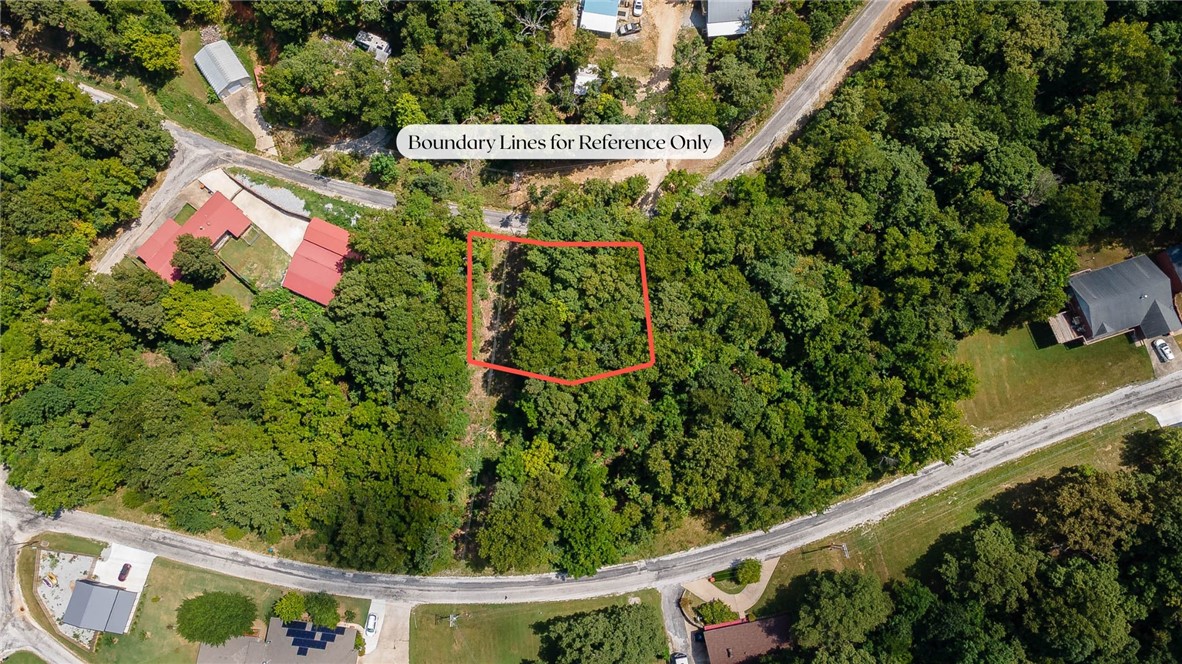 Awesome opportunity to own land and a boat slip on Beaver Lake in War Eagle Cove S/D!! 0.289 acre lot with wooded terrain. Fully paved roads all the way to the property. Bring a camper or perfect for a walk out basement. Enjoy a boat slip in a community dock that is a nice flat grassy walk to access!! Water is across the street. Electricity is at the road. Zoned for Springdale Schools.