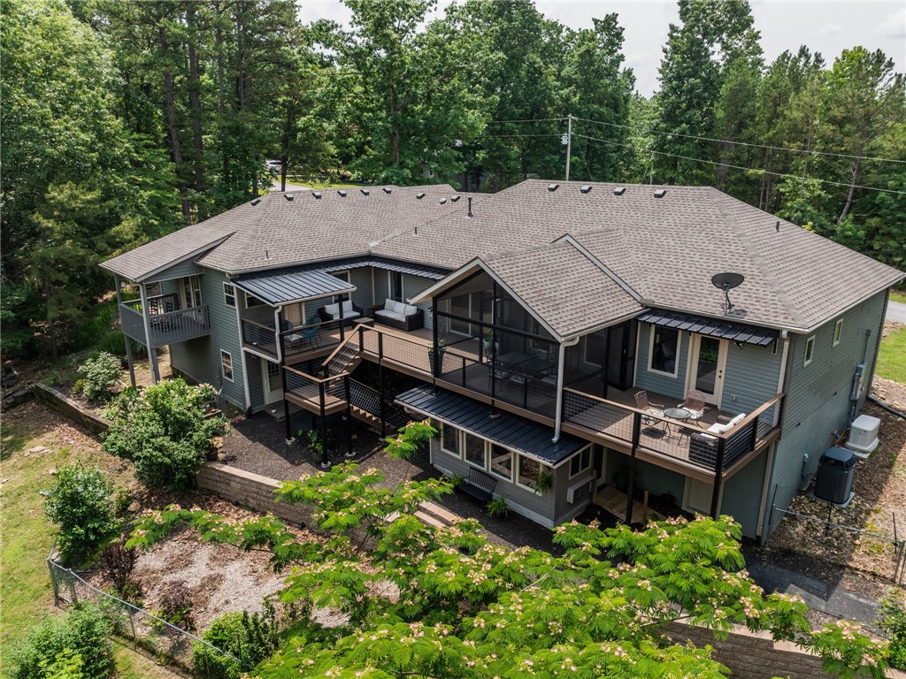 Welcome to Your Beaver Lake Oasis, this is more than just a home, it offers a lifestyle. 5.01 acres of privacy. Hop on your golf cart & cruise down to the community dock with your own slip. The semi-open layout seamlessly connects the dining area, living room, & kitchen. The kitchen overlooks a sprawling deck that is excellent for entertaining or relaxing after a long lake day. The main floor features two primary suites. Second suite is complete with a full bath, living space, kitchenette, & private deck. Off the kitchen is a versatile office space. Downstairs, you'll find a finished bonus room & full bath. Perfect as a game room, workshop, guest quarters, etc. Outside, additional bonus space with its own entrance that could be a home gym/movie room/etc. This home has been thoughtfully updated throughout. Ask for the full list of improvements! Whether you're looking for a peaceful full-time residence or a weekend escape, this home has it all! *Additional boat slip and 2.60 acres across the street also for sale.*