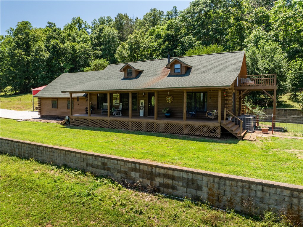 Charming Log Home Retreat on 88.35 Acres
Discover the serenity of this well maintained log home nestled on 88.35 acres of breathtaking landscape. With stunning views and abundant natural beauty, this property is a true haven for nature lovers, farmers, and hunters alike.The land features approximately 46 acres of woods and 42 acres of lush pasture, ideal for cattle, horses, and goats, complemented by cross fencing for optimal management. The well-maintained property boasts three barns, providing ample space for storage and equipment. Enjoy the outdoors with three stocked ponds and a year-round spring creek.The log home itself has been beautifully renovated, offering modern comforts while retaining its rustic charm. The main floor hosts spacious bedrooms. A walk-up loft, currently utilized as a bedroom and office, offers additional living space and stunning views. Whether you seek a tranquil retreat or an active lifestyle, this sprawling property is ready for you to call home.