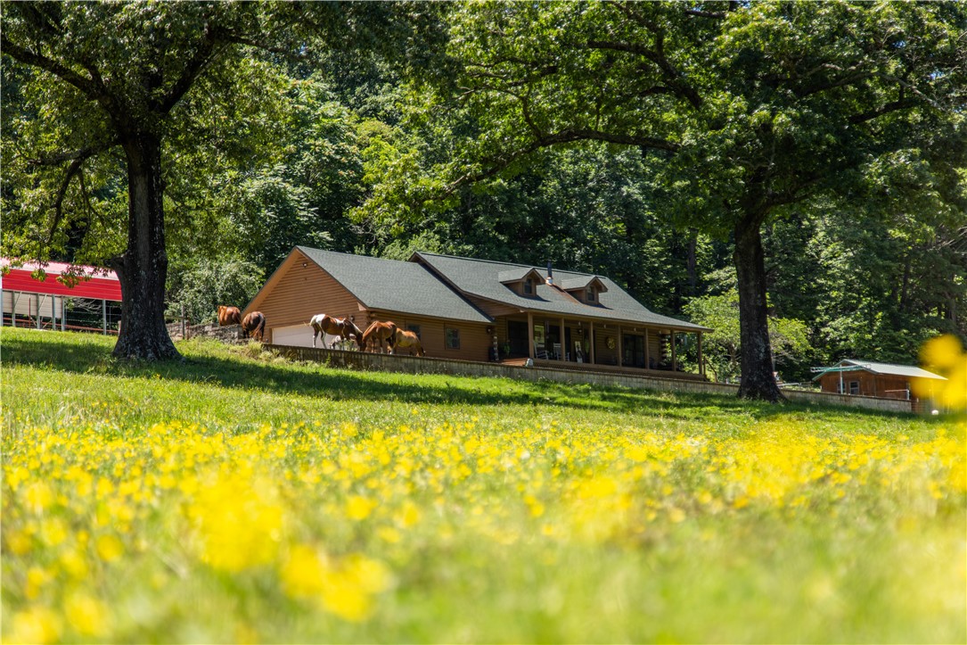 Discover the serenity of this well maintained log home nestled on 88.35 acres of breathtaking landscape. With stunning views and abundant natural beauty, this property is a true haven for nature lovers, farmers, and hunters alike.The land features approximately 46 acres of woods and 42 acres of lush pasture, ideal for cattle, horses, and goats, complemented by cross fencing for optimal management. The well-maintained property boasts three barns, providing ample space for storage and equipment. Enjoy the outdoors with three stocked ponds and a year-round spring creek.The log home itself has been beautifully renovated, offering modern comforts while retaining its rustic charm. The main floor hosts spacious bedrooms. A walk-up loft, currently utilized as a bedroom and office, offers additional living space and stunning views. Currently a 2 bed 1 bath with loft. Seller will credit the cost to finsih the loft for a formal primary bed and bath. MLS attachments highlight special features. Also listed as Farm mls 1317912