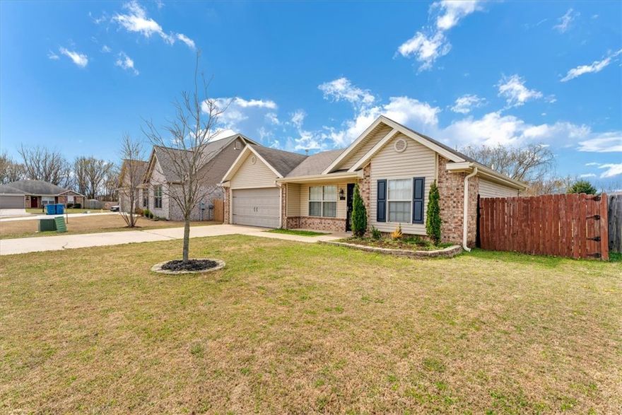 Located in a highly desirable west Bentonville location, this well maintained and updated 3 bedroom 2 bath home offers the perfect blend of comfort and convenience.  The home features a split 3/2 floor plan for added privacy. Bright open feel with  granite countertops, subway tile backsplash with a farmhouse sink and custom styled herringbone brick tile with all appliances included, including Refrigerator and Washer and Dryer.   The custom Barn door in the primary bedroom leads to  the entrance into the primary bath with large walk-in closet.  Walnut shelves accent the bathrooms, laundry room, kitchen, and living room. In the living room you will find an accented white shiplap wall.  The large back yard is perfect for entertaining or playing with a pergola covered back patio and a shed for storage or as a playhouse. Subdivision is located close to Bentonville Schools and the Bentonville Community Center. Homes in this area move quickly-don't miss your chance to make 5408 SW Remington yours.