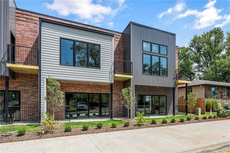 Experience sophisticated living in the heart of Bentonville, just across from the 10th & J Street entrance to the new Walmart Home Office. These elegant, two-story townhome-style condos offer a seamless blend of style and convenience, complete with a private attached garage.
The open-concept kitchen boasts an abundance of white oak cabinetry, sleek quartz countertops with ample seating, and a premium appliance package, including a refrigerator and full-size washer & dryer. Designer finishes elevate every space, while the primary suite features a private balcony, walk-in closet, and spa-like bath. With 2.5 beautifully appointed bathrooms, luxury meets functionality. Grounds are professionally landscaped with sprinklers. 
Located in SoMa District, enjoy a walkable lifestyle near top restaurants, coffeehouses, The Momentary, and the Razorback Greenway. Experience urban luxury in Downtown Bentonville welcome home to SoMa Terrace.