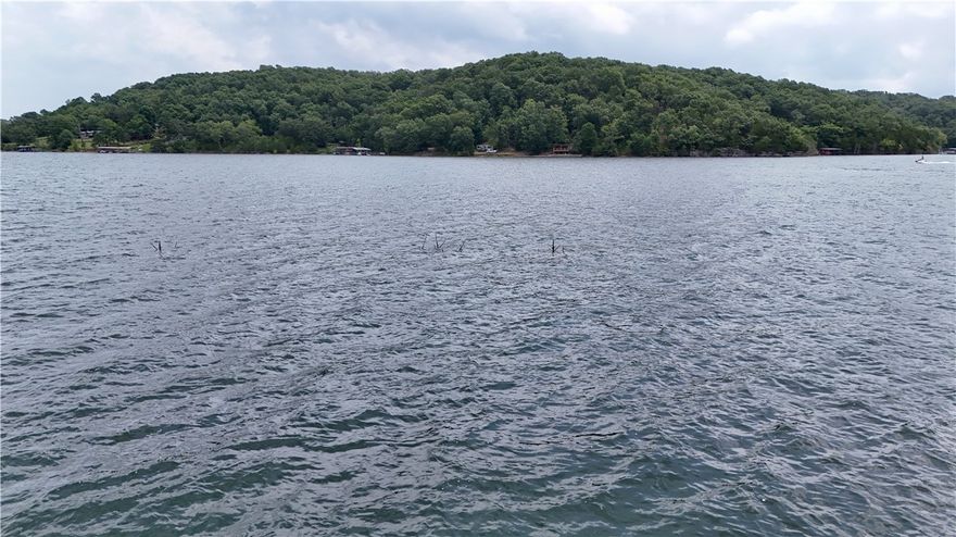 The Perfect slice of Beaver Lake Life Awaits YOU!!!  1.06 acres  Lots 8,9,10 all together is 680ft of shoreline ZONED FOR BOAT DOCK on North end of Beaver Lake near Point 4 giving you Breathtaking Panoramic lake views.  Site is  Buildable with a level area nestled within a wooded buffer providing both flexibility and seclusion an ideal canvas for your dream lake home. Carefully selective clearing ensures unobstructed vistas across the water—perfect for sunrise and sunsets. Level building site is close to shore for easy walk to the water/shoreline!  Paved road access, available electricity, and ability to install well and septic systems with generous space remaining for outbuildings, motorhome parking, lake equipment and your own homegrown garden. 
Located in Cedar Acres subdivision close to Airstrip,  Lost Bridge Village, marina,  tennis, pool, and community hall.   
Clean canvas to design and build exactly how you envision whether it's a weekend getaway or year-round residence.  Property zoned for private dock