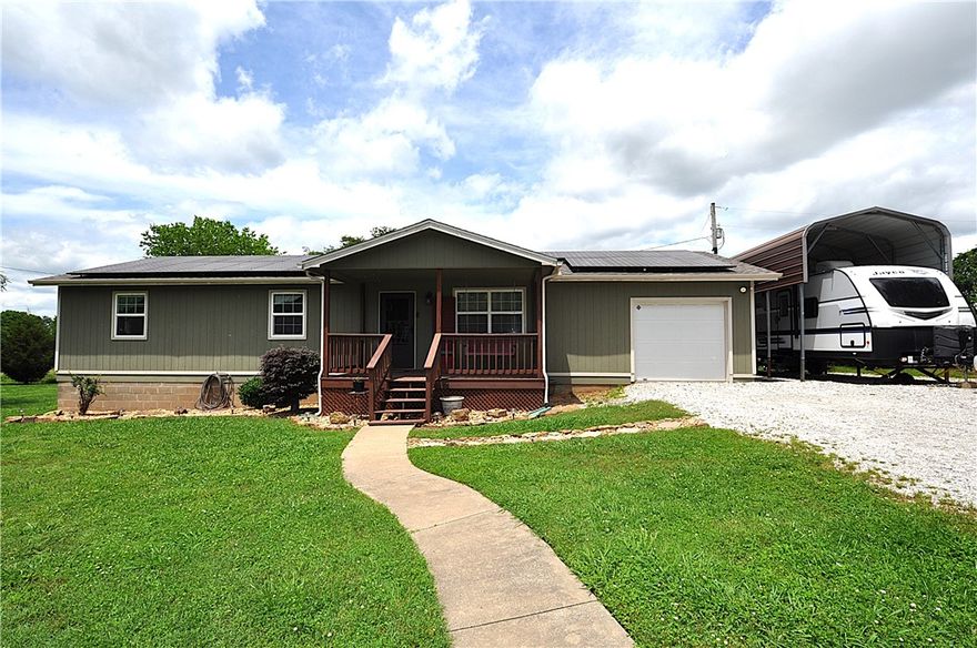 Own a piece of paradise. Close to everything you need but you'll feel like you are away from it all on 1.23 acres. House includes 2 patios on the back of the house that overlooks a large pasture area. There is a single car garage that has been used a studio. It is climate controlled with water-could be plumbed for a full bath. The house has 3 bedrooms/2ba and has been remodeled with a modern country feel. One bedroom was previously used for an in home daycare. Floors are laminate and recently installed. New roof. Covered RV parking, with electric hookups. Huge detached shop could be used for auto repair business, includes paint area and auto lift with separate electric bill.  Home is totally electric and includes solar panels.