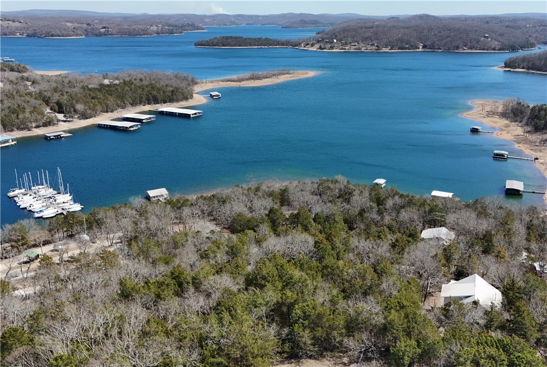 Welcome HOME to a unique opportunity to create your dream home on Beaver Lake. Nestled on 1.12 acres, the custom-built house features a built-into-the-hillside design enhancing the stunning views. The expansive wood deck provides a perfect spot to enjoy the scenery while the main level boasts an oversized family room with custom cathedral ceiling, spacious kitchen & dining area, a primary suite, & an unfinished half bath. Upstairs, you'll find 2 oversized bedrooms sharing a full bath. A standout feature of this property is the additional dwelling unit beneath the main level, including a full kitchen, bath, & two bunk roomsāideal for kids' sleepovers or guests. While the home requires some finishing craftsmanship - 2 functioning staircases, primary & half baths - its solid structure and picturesque location offer endless potential. Located around the bend from Beaver Lake Sailing Club, this property is an unfinished canvas ready for a vision & dedicated contractor to transform it into HOME. Home to be sold "AS IS."