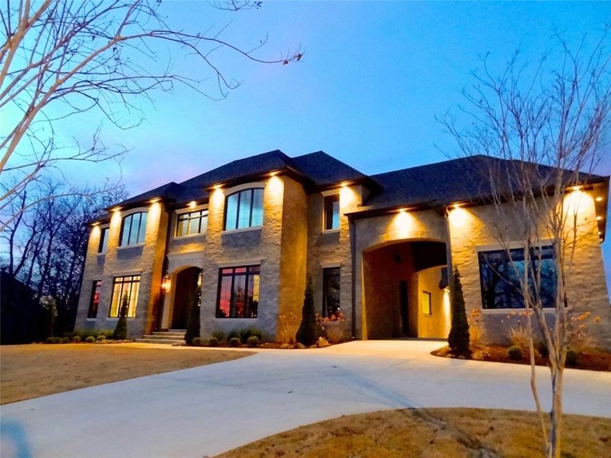 Exquisite executive home with Mother-In Law/Guest house. Modern design like no other in NWA features mortar/sand/color finish over brick, handcrafted concrete paver floors, Windsor windows, energy efficient appliances. Main house is 5168 SF with 5 En-suite bedrooms. Salt water pool. Guest house is 1674 SF with 2 en-Suite bedrooms.