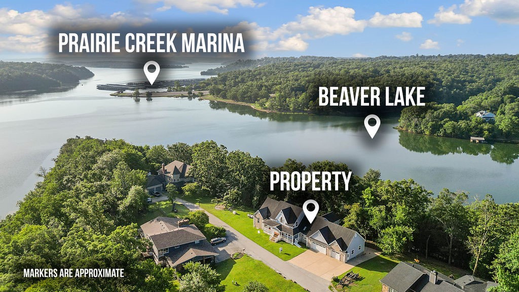 Lakefront Luxury Awaits! This custom-built, one-owner home sits just minutes from Prairie Creek Marina and includes TWO boat slips on a private dock with Solar for electricity. Offering 3812 sq ft of lakefront living, 4 bed, 2.5-bath home features seasonal Beaver Lake views. Enjoy a spacious kitchen with a custom gas range, large island with bar seating, an additional large bonus room- currently used as a pool room of the kitchen and a large living room with a gas fireplace. The primary suite features gas fireplace, private deck access with a hot tub. Upstairs, a flexible space serves as a 4th bedroom or additional living/game room. This home comes with incredible extras, including a whole-house generator, a covered front porch, a 3-car oversized garage with a 4th bay, and a wraparound driveway. Minimal yard maintenance with a Corp line near the back means more time to relax and enjoy the lake. Don’t miss this rare opportunity to embrace the lake lifestyle—summer on Beaver Lake is just beginning!