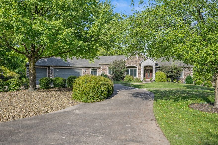 Close to Branchwood- pickle ball, walking trails, indoor swimming gym,  Branchwood Nature Trail and more!. This O.A.K.–built home offers exceptional quality with 11’ ceilings, solid oak floors, poured-concrete foundation, and rare privacy on three lots totaling .98 acres. Enjoy stargazing from your deck, pick fruit from mature plants, or simply unwind in total seclusion. Inside, you’ll find two fireplaces (including a brick-surround Kozy Heat gas log), a wall of windows overlooking the patio, and 1,100+ sq ft of climate-controlled storage plus a 3-car garage with a concrete circular drive and full house back-up generator. The lower level is ideal for multi-generational living with a large wet bar, full-size refrigerator, storage under the stairs, full bath, spacious bedroom, and interior workshop with workbench, utility sink, and HVAC. Double doors open to a private patio. Close to lakes, golf, and walking trails—this home blends comfort, function, and nature.