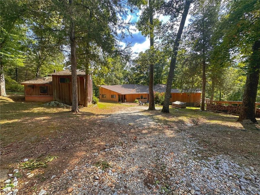 Enjoy all the space and privacy with two cabins secluded on 28.32 acres. 3 BR, 2 Bath 2800 sqft main cabin + 680 sqft 2 BR, 1 Bath guest cabin. Frontage on the Little Buffalo River just 13 miles from Jasper. Featuring 180 degree panoramic mountain views inside the cabin. This property features a hot tub, a fire pit, and mowed walking trails leading down to the river. It also includes a home generator that powers both residences, an entire water filtration system, and a 1,000 gallon propane tank. The homes are currently used as nightly rentals.  This home has a SECRET: Even though it now has central heating and air. The original center fan shape of the home is heated by the sun in the winter and cooled by the mountain breezes in the summer, using no electricity or gas. This home was designed by a renowned architect James Lambeth in the 1970s. It’s one of the few original solar homes, created long before modern solar technology. This home has been featured in a several books about passive solar architecture.