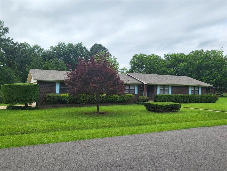 Beautiful Brick 4-Bed, 2 bath home completely remodeled in 2024 and ready to welcome it's new family! This home has been lovingly updated including a new roof, HVAC, freshly painted top to bottom, with luxury vinyl floors! The kitchen has been enlarged to include a dishwasher, large single bowl sink, quartz counters with LOTS of room to enjoy preparing meals and entertaining. Floating solid teak shelving helps complete the modern look! Two spacious living areas, one with a wood burning fireplace, give you the space to really enjoy living in your new home! Lots of quality touches, like new Levolor window blinds are found throughout this home. Includes a oversized double garage, a big deck just right for entertaining, a storage building, and a beautiful landscaped corner lot, with room to garden or just sit back and enjoy!