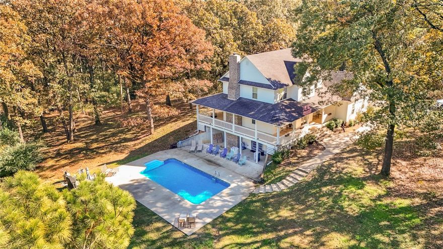 One-of-a-Kind Country Escape on 11.69 Private Acres! This stunning property offers the peace and privacy you’ve been searching for. The spacious two-story home with a walk-out basement includes 3 bedrooms, an office, 2 full baths, 2 half baths, plus an additional shower in the laundry room, giving you unmatched convenience. Inside, you’ll love the granite countertops throughout, and a cozy wood-burning fireplace. The finished basement serves as a second living area and opens directly to the 16' x 32' in-ground pool, creating an ideal indoor/outdoor entertaining space. This home also features a FEMA-spec, county-registered safe room, a 2-car garage, a laundry chute, and two central heat & air units for efficient heating and cooling across both levels. Kitchen appliances convey. Step outside and enjoy the quiet country setting from the three-sided wrap-around porch, perfect for morning coffee, evening relaxation, or watching wildlife across your private acreage. This property truly feels like its own retreat.