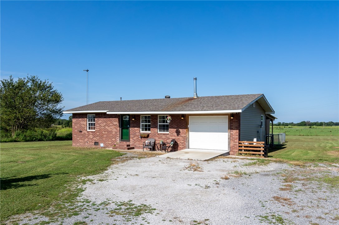 Adorable starter home! 2 bedrooms, 1 bath, maintenance free exterior home on almost an acre (.83). True hardwood flooring that can be sanded & refinished with vinyl & tile in the wet areas. A Harmon wood stove in the living area will heat the entire home in the winter, reducing the need to refill the propane tank. Eat in kitchen is open to the living area and offers updated appliances, along with tons of storage space & prep area for cooking. Office area built in to utility room makes it perfect for working from home with the high speed internet that's available. Covered patio is great for evening gatherings with friends. Partially fenced backyard for the dogs. 1 car garage & 10x14 Storage building. Paved road. Window AC in bedroom will convey-it's used to stay super cold when you sleep!
