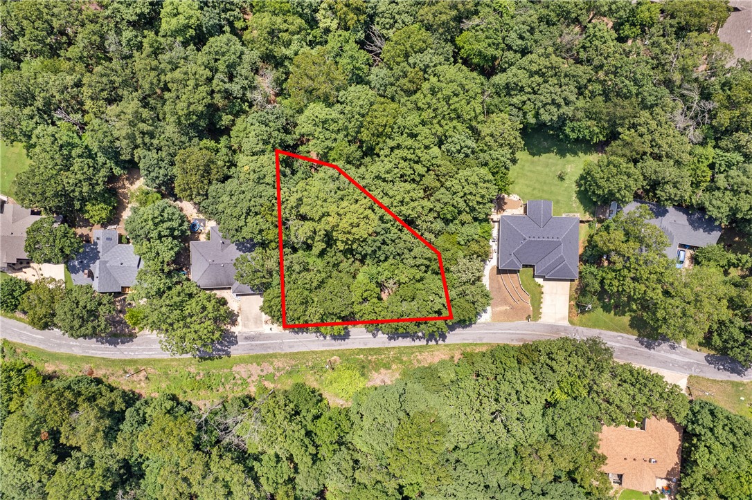 Introducing a rare opportunity to own a secluded, wooded 0.28-acre lot in Bella Vista's sought-after Blenheim Lane community. The gently rolling terrain and mature Ozark pines provide a tranquil, private canvas to build your custom home. Enjoy easy access to the renowned Tunnel Vision and Sugar Bridge mountain biking trails, placing outdoor adventure right at your doorstep. Positioned just moments from a wealth of recreational amenities, this parcel is perfect for lovers of the outdoors and community-minded living alike. With public streets, POA membership, and city services, this prime lot stands ready for a visionary build. Donāt miss your chance to claim your slice of Bella Vistaās active, amenity-rich lifestyle.