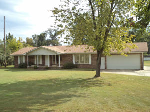 well constructed 70's home, brick on crawl space, Dover water and sewer, 3 bedrooms, 2 full baths, large laundry room with exterior door, den and living rooms, good kitchen, built-in microwave, French doors to patio, large double garage with storage room, extra deep lot, garden, 6 ft deep front porch,