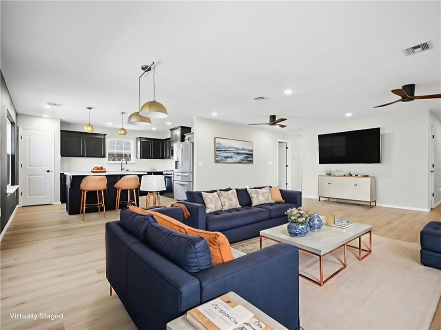 Welcome to 720 Madison Dr in Prairie Grove! This solid brick, 4-bed, 2-bath home features a split floor plan with the primary suite privately tucked away from the other bedrooms. New AC (3 yrs), 80-gal water heater with recirculating pump (5 yrs), and guttered architectural shingle roof deliver peace of mind. Enjoy new LVP flooring, LED lighting, and an open-concept layout. The kitchen shines with a custom locally crafted island with quartz top, new granite countertops, subway tile backsplash, 5-burner gas range, pantry, and dishwasher—fridge conveys. Ceramic tile in wet areas, carpet in bedrooms, plus attic storage. The 2-car garage offers industrial shelving. The large, low-maintenance backyard features mature peach trees, a grape vine, cypress, and two blooming tulip trees—all behind a 6-ft privacy fence. Steps from Prairie Grove Elementary, Jr. High & High School, Muddy Fork Park, and the fenced dog park!