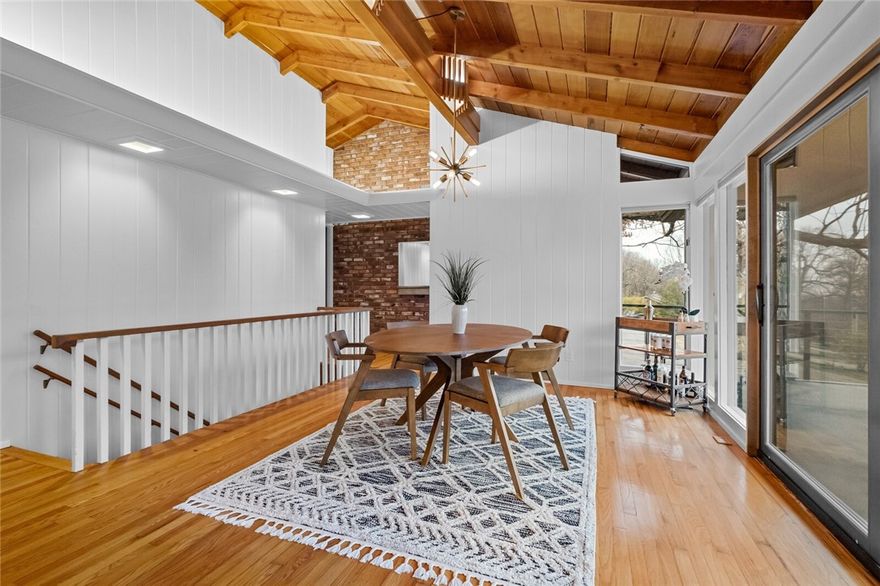 This Mid-Century Modern home-designed by renowned Architect and former UofA Professor Cyrus Sutherland-sits on 1.14 acres on Mt. Sequoyah in East Fayetteville. While recently updated, this iconic residence boasts many original features: floor-to-ceiling windows, vaulted ceilings, cedar exterior, brick interior accents & period lighting. The main house offers 3 bedrooms, 2 living areas, an office/nursery, a sauna & 2 updated bathrooms. The 914 sq ft cottage features 2 open bedrooms, living room, bathroom, & kitchen... ideal for mother-in-law quarters, teenagers, or guests. The combined square footage of both homes is an impressive 3903 sq ft.  Updates in 2023: new HVAC in main house, new AC in Cottage, new sliding doors, new flooring (carpet & tile), remodeled bathrooms w/new fixtures, new kitchen appliances, new lighting, new ranges/refrigerators, new hot water heater, new electrical panel, exterior stain, exterior lighting, gutters, interior paint, & more. Roof was replaced in 2022.  Don't miss this one!