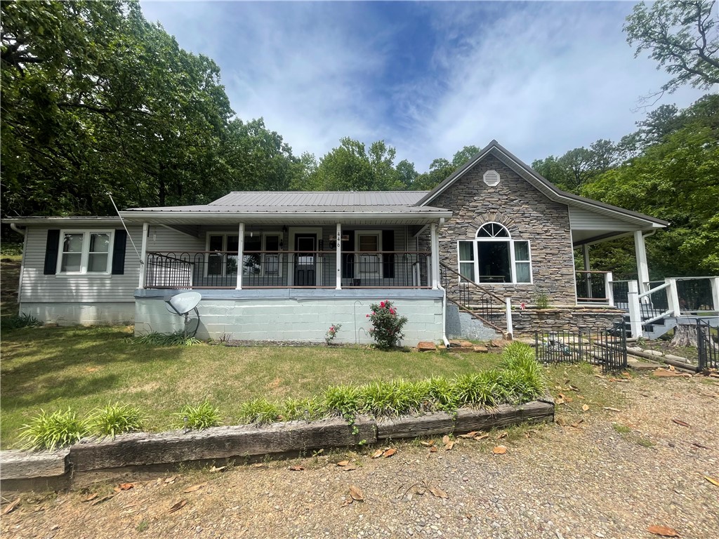 Captivating and excitedly different, gorgeous country home sits on 2.28 acres and is surrounding by forest and views. Charming inside and out, updated & striking- offers 2 covered porches/decks, gorgeous lawn, storm cellar, storage building, chicken condo. The interior is absolutely delightful! 2 family rooms, office, huge master suite with palatial bathroom! Gas fireplace is the focal point of the newest family room. Remarkable and filled with loads of sunlight, this dwelling will capture you in a heartbeat! WALKING DISTANCE TO LAKE LUDWIG! See PRIVATE REMARKS.