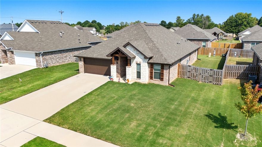 Welcome to this beautifully maintained home in the desirable Deere Creek Subdivision, surrounded by many new construction homes — yet offering upgrades that set it apart. Step inside through a lovely arched entry into a spacious open-concept living area featuring extensive crown moulding and a corner brick fireplace. The kitchen offers plenty of counter space, black stainless appliances, gas cooktop, & a corner pantry for extra storage. Ceramic wood-look tile flooring runs  throughout the entry, living, dining, and wet areas for both beauty and easy maintenance. This split 4-bedroom is ideal for anyone needing a dedicated home office. The primary suite features a tray ceiling and a luxurious ensuite bath with double vanities, a soaking tub, a tiled-to-the-ceiling shower and a spacious walk-in closet. Outside, you’ll love the home’s curb appeal with its brick and stone exterior, wood accent shutters, and a vaulted covered front entry w/wood beam Ideally located just minutes from I-49, Walmart, and Shaw Family Park.