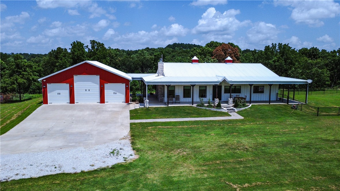 Welcome to your dream country escape! This modern farmhouse blends comfort and rural charm with standout features throughout. Inside, enjoy a professional-grade Fisher & Paykel 5-burner range with griddleāideal for the home chefāand a FamilySAFE storm shelter for added peace of mind. Step outside to a massive 1,786 SF covered patio overlooking a fully fenced 5,340 SF yardāperfect for entertaining, pets, or play. A 1,480 SF detached garage with three drive-in doors and a 3,430 SF pole shed offer endless storage or workshop options. Set on beautifully maintained acreage with panoramic views, wooded surroundings, and a 0.5-acre stocked pond, this one-of-a-kind property offers luxury, utility, and serenity all in one. Donāt miss it!