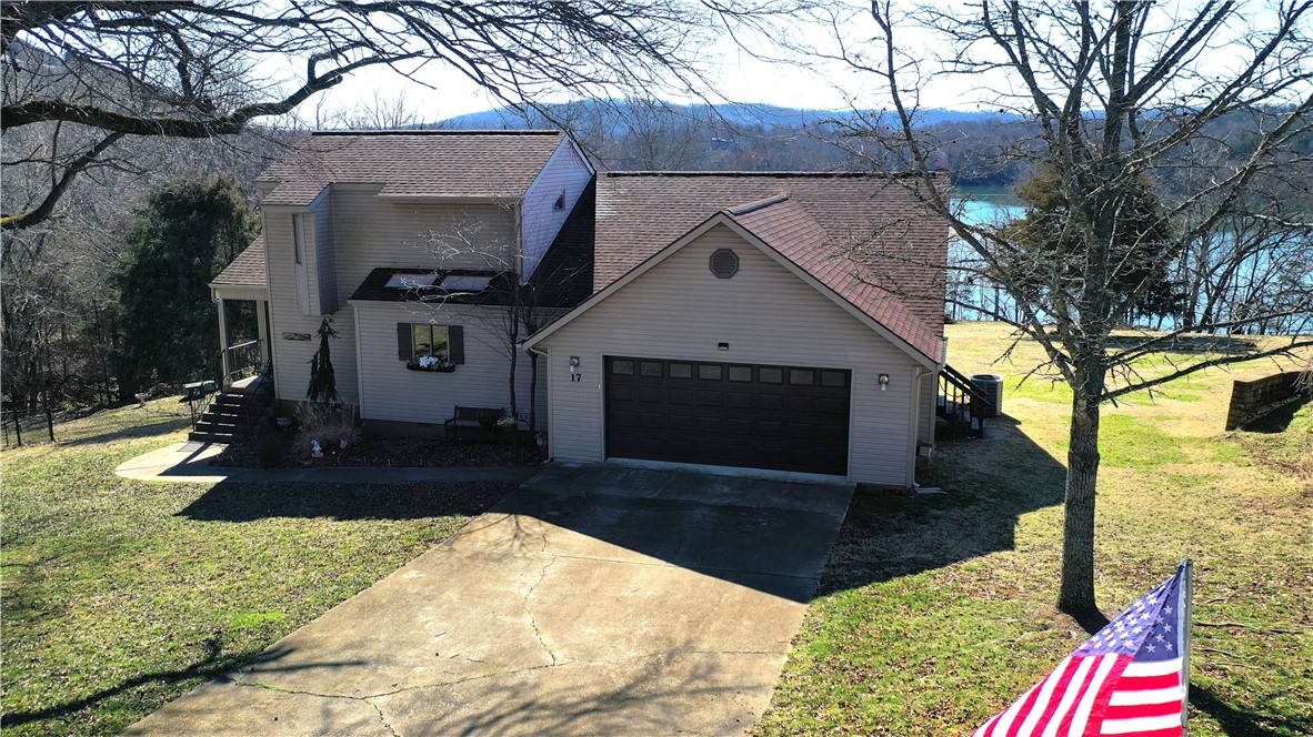 True lake front home with an amazing price adjustment! This extra large lot has a cool trilevel home with amazing views of the lake and mountain vista. Easy access to the lake, proximity to pool and recreation center, 9 hole golf course and more. All electric with gorgeous native stone "ventilator" fireplace. Roof, gutters and downspouts replaced 2023, newer wood flooring, built-ins, tons of storage, 3 bedrooms with massive owners suite and 2.5 bath. Spend your days watching the wildlife or playing at the shore. All kitchen appliances and washer/dryer convey at no additional cost. Furniture available for negotiation.