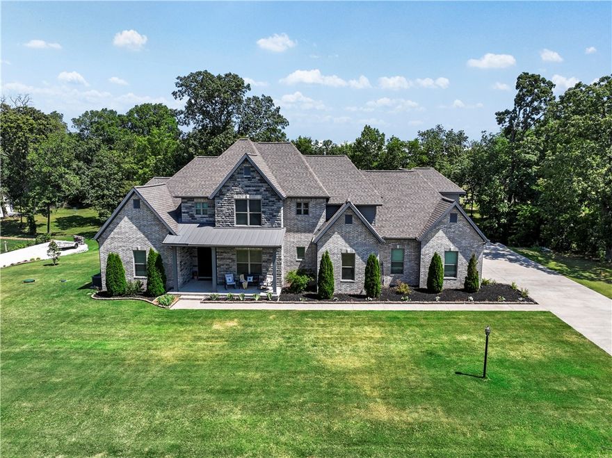 This custom-built home offers unparalleled craftsmanship and quality providing almost every in-home convenience imaginable.  Perfect for entertaining and everyday living, this stunning property features a very large and pretty patio area overlooking a spacious, tree lined backyard.  An acre setting offers lots of privacy and room to enjoy outdoor activities.  This is a must -see for those seeking a beautiful and functional luxury home.  Lots of crown molding, wood wrapped windows hard wood flooring and high ceilings through-out. Storage galore.  Professional photos capture the exquisite details and beauty of this home, highlights its superior craftmanship and luxurious finishes. 

Convenient Location:**
- **Shaw Family Park:** Directly across the street.
- **Willis de Shaw Elementary:** 1.3 miles.
- **Bypass:** 1.8 miles.
- **J.B. Hunt Corporate:** 7.2 miles.
- **Walmart Supercenter:** 3.2 miles.