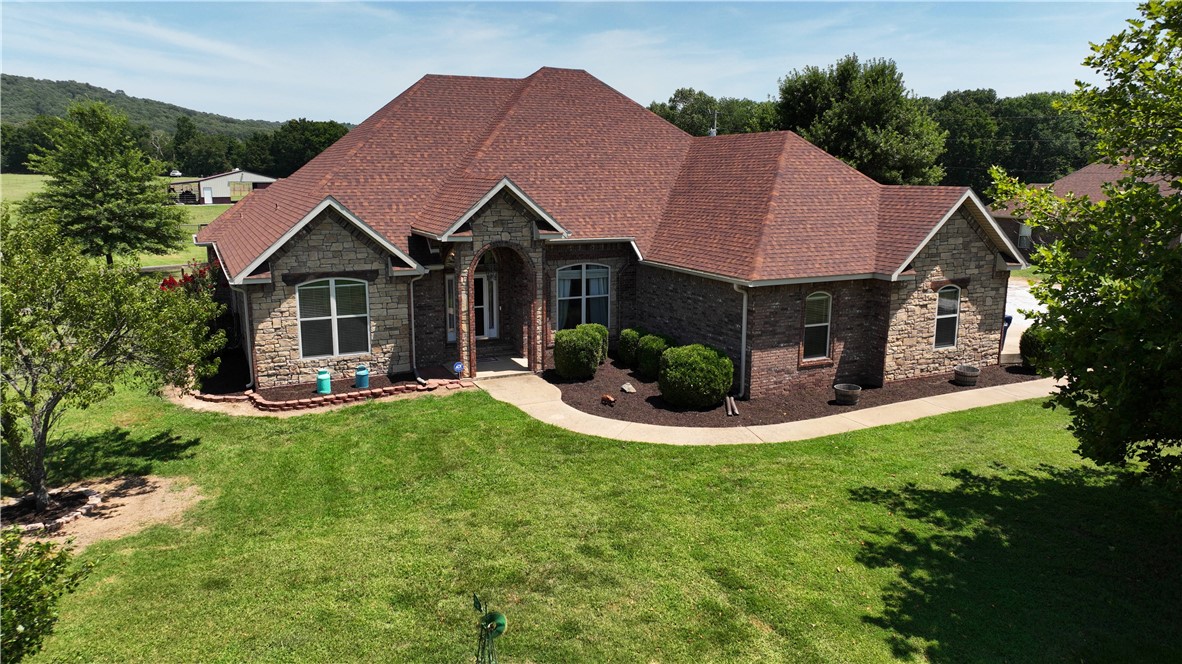 MOTIVATED SELLER. All brick & stone breathtaking Equestrian & Cattle Paradise nestled on 8+ acres only 0.75 miles to all your shopping needs. Turn key, fully fenced & ready for a great investment opportunity w/side pasture as an additional building lot. Huge 3 car extra deep garage w/workshop brings you into a grandiose open floor plan, 10 ft ceilings & custom bar for a cold beverage. The cozy family rm set up for projection movie nights & huge eat-in Kitchen w/island open to LR rm w/custom rock, wood stove fireplace & a 2nd Centrally located gas fireplace- perfect for entertaining guest. A Primary Suite presents a soaking tub, walk n shower & ginormous walk n closet. A 4 stall breeding horse barn w/hay storage tack rm, water electric & concrete floor dresses a perfectly manicured lawn. Electric & water in all pastures. Enjoy a beautifully landscaped backyard oasis & scenic views while you sip your morning brew at sunrise & finish your day stepping onto a party lit covered deck for a soak in the hot tub at sunset.