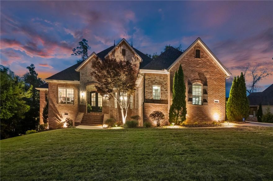 Set w/in the sought-after gated Shadow Valley community, this 4298 sqft estate offers refined golf-front living along the 7th hole, nestled on a beautifully landscaped half-acre w/ mature trees & ambient lighting.  The thoughtfully designed floorpan features 4 bdrms & 4.5 baths, including a spacious main-level primary suite w/ an expansive walk-in closet & spa-like bath. Upstairs, you'll find 3 generously sized ensuite bdrms along w/ a versatile bonus room. The gourmet kitchen is a true centerpiece, showcasing quartz countertops & backsplash, a large center island, Wolf appliances, built-in refrigerator & coffee maker, all seamlessly opening to the inviting living room. The home also includes a formal dining, cozy den w/ full bar & dedicated office. Step outside to relax on the covered back porch or gather around the gas fire pit while taking in the peaceful, tree-lined privacy & sweeping golf course views. More highlights include an oversized 3+ car garage, attic storage & invisible fence. Golf Membership conveys.