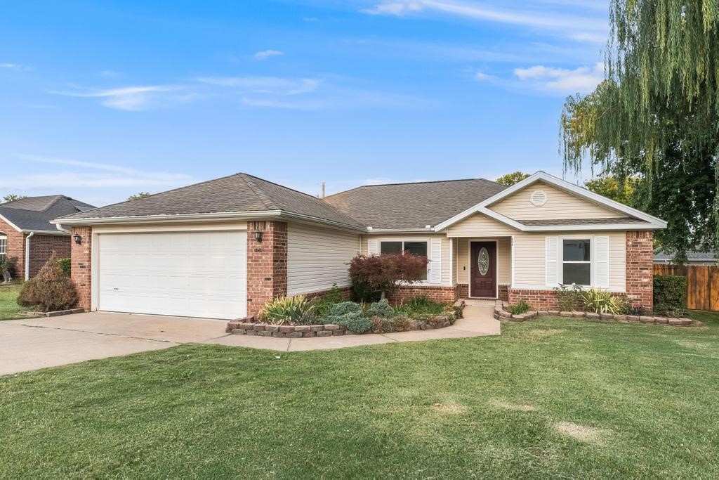 Freshly updated and move-in ready! This home features a desirable split floor plan with all new flooring, paint, and trim throughout. The open living area includes a cozy wood-burning fireplace for winter nights. Kitchen features granite counters, pantry, and gas and electric hookups, and the dining space conveniently connects to the backyard. The primary suite offers a relaxing Jacuzzi tub, walk-in shower, new vanity, and walk-in closet. Step outside to a covered deck overlooking the backyard, complete with a sectioned-off dog run, ideal for pets or a garden space. Additional features include CCTV setup, a SMART security system. Conveniently located near Gamble Elementary, Centerton amenities, shopping. Major updates include: roof, HVAC, and windows all replaced in the past 6 years.