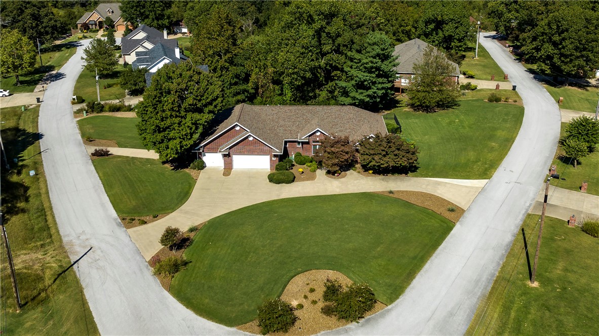 Beautiful Custom Built home 5 min from Dwntn Rogers & Prairie Creek Marina on .75 acres. This home greets you w/a circle driveway,lrg flat yard & manicured landscaping.Ā On the main level,you will find an open floor plan w/high ceilings,gasĀ fireplce & refinishedĀ hand-scrapedĀ wood flooring.Ā Enjoy both an eat-in kitchen w/gorgeous granite countertops & a frml dining rm that doubles as a cozy den. Enjoy a splitĀ floor plan w/Primary en-suite,double sinks & walkin closet.Completing the main level are 2 spacious bdrms,full bath,1/2 bath, laundry rm & custom built-in storage throughout. Brand new deck(2023).Dwnstrs 4th bdrm,full bath, lrg office w/built-in cabinets,custom-built bar,granite countertops, full size refrig,sink & dishwasher w/ Nature Stone flooring in bar area & rec room. Watch all your favorite games w/theatre-styleĀ seating on the 102-inch projection screen & surround sound w/large game room.Backyard features a steel fence & beautiful firepit. 4 car garage.Whole House Generator 2010 New Roof 2020