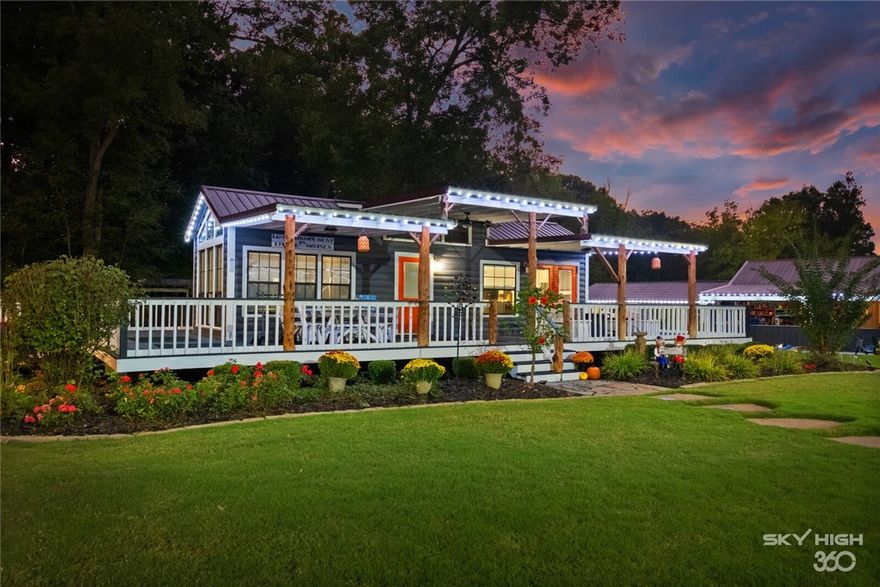 Six plus acres of resort style heaven in NWA. Four homes on the property made for vacation style short term rentals. Perfect for Weddings, Events, Family Reunions, Work or Social Retreats. The main house has 2 bed/2 bath and 2470sq ft approx.  Three other houses with 1 bedroom each. All homes are heated and air conditioned. Beautifulheated  pool amid the tiny homes. Natural pond and creek surround the property. Homes are completely served by Solar System which can be transferred to new owner. Completely covered outdoor kitchen. Beautiful Firepit just made for group conversation. Barn can be turned into event center with access to screened in patio area overlooking the gorgeous creek. great room can be an indoor game room, office, man cave, or media room. Three plus acres undeveloped could house even more accommodation or even space. Did I mentoon a Stocked pond so bring your fishing polls!