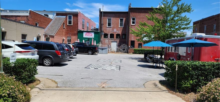 If you are thinking you would love to have a business in downtown Siloam Springs, this is the only available, buildable lot left.  Located in the Historic District with historic overlay zoning 102.50.1 and  Commercial 1 zoning. This lot is can have a one or two story building. Access from both Mt. Olive and Alpine. Note: Cars pictured are currently allowed by owner to park on property. Food truck is renting space and does not convey. Lot boundaries shown on available survey. Owner financing available with qualifying credit report, 6% interest and approved down payment.