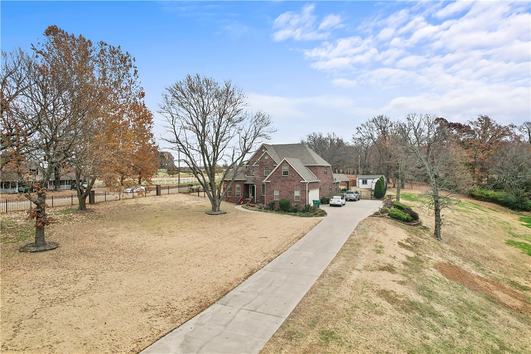 Beautiful all brick home on a 2+ acre corner lot with inground pool & hot tub! Properties like this in the prestigious Buckingham Estates don't come along very often! The oversized primary suite is conveniently located on the main floor & features a sitting area & newly remodeled primary bath w/ fresh paint & flooring. A secondary bedroom, plus full bath is located on the separate side of the main floor. Upstairs has a full bath plus three bedrooms, one of them large enough for a bonus/media room. The kitchen is surrounded by places to entertain guests with two dining areas & a large pass thru to the large living room. Kitchen amenities include an island, dry bar, large sink, stainless steel appliances & quartz countertops. Off the kitchen is the back yard oasis! Not only is there a hot tub & inground pool, but also an outdoor grilling station, two gazebos, surround sound & a covered fire-pit area! The fully fenced yard is professionally landscaped with two storage units. Extended driveway w/ side load garage.