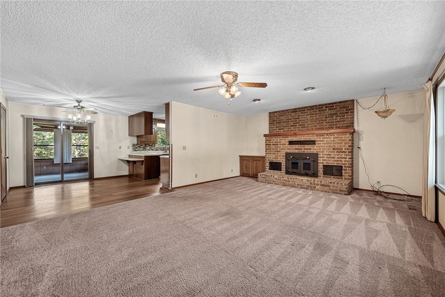 Discover a Bella Vista retreat just up the street from The Beach at Lake Avalon and popular mountain bike trails---perfect location for nature and adventure!  This home has been converted to sewer already and is zoned for Bentonville Schools. It features a heated & cooled sun room right off the kitchen, a huge unfinished walk-out basement/workroom with 2nd garage door in the back, an extended deck on front porch, a laundry room off of the primary bedroom and a brick wood burning fireplace ducted throughout the house. Some recent updates include LVP flooring in kitchen and hallways and new Pella windows in kitchen and living room plus a new front door. Enjoy being minutes from all Bella Vista has to offer!