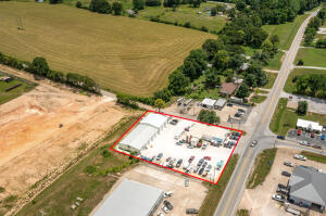 Excellent Commercial Location. Located at the intersection of Hwy 7 N & Hwy 43 E, 165 fee of Hwy 7 Road Frontage. 1,000 sq ft of Showroom, 1,456 sq ft Apartment with 1,236 unfinished Basement, plus a 50' x 143' Shop Building with 8 Overhead Doors. Selling Real Estate Only.