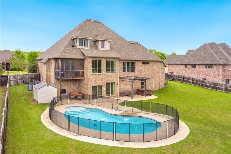 Showstopper in sought after Stone Mountain Subdivision. Love at first sight as you open the door and are greeted by soaring ceilings, grand staircase, formal office with built-in bookshelves and formal dining room all with beautiful wood floors under your feet. Living area showcases a gorgeous fireplace and continues to an amazing kitchen with lots of granite, plenty of cabinets, double oven, beverage bar, gas range, pantry, built-ins and inviting hearth room with screened porch. Primary on main level with en-suite featuring custom stream shower, his/her WIC's, dual vanities and soaker tub. Family gatherings downstairs with huge play room, movie room with all equipment and concession area, 300 bottle wine closet, informal office, guest room with en-suite and 2 additional flex rooms. Upstairs adds FOUR more bedrooms, one with en-suite and two sharing Jack and Jill with last being used as workout room. Large fenced backyard has heated mineral pool, hot tub, shed and fruit trees.