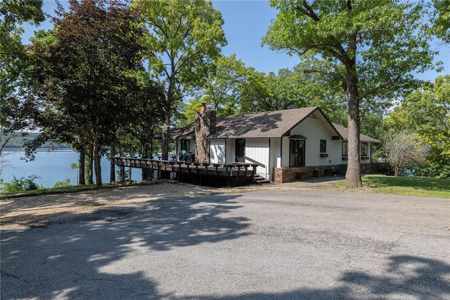 If you are looking for easy water/dock access and views that can't be beat, this one is for YOU!  Tired of looking at properties with a treacherous hike to the water and/or dock?  Not here!  The proximity to the water isn't sacrificed for the view on this one.  It's truly a gem.  This property features one of the best views on the lake, situated perfectly at the end of a cul-de-sac. The home is perfectly placed on the point for 180 degree views of Beaver lake from the massive deck and living areas. What's better?  The home sells turn-key with all upscale furnishings, boat, jet ski, side by side, and a slip in a co-owned dock with swim platform included. The 4 bed 2 bath home is setup perfectly for a second home or full time living, and you don't even have to buy a thing. . . just move in and enjoy the serenity of your own, private lake oasis! This home features many high end finishes, brand new HVAC, and a whole house generator with remote monitoring. No expense has been spared with the endless updates here!