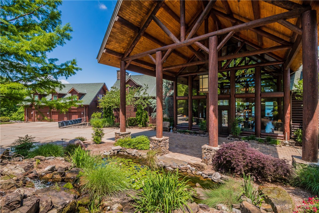 Step into this luxurious, Greers Ferry Lake retreat, artistically crafted log home, and nourish your mind, body and spirit. Offering endless possibilities, this fully furnished estate features a gourmet kitchen, a 40’ vaulted wood-beam great room with a stacked stone fireplace, open dining room, a recreation room with wet bar, an exercise room, 12 bedrooms – each with their own bath or access to shared bath and all with private views of the lake– plus a detached 3-car garage area with 2 separate apartments. This home boasts exceptional access to outdoor recreation, with peaceful panoramic views that will make you feel embraced by nature. Privacy is an understatement when it comes to this 22,000 square-foot lakefront estate. The spacious living areas inside combine with the 5.82 acres outside to form the ultimate secluded corporate retreat or vacation home. Home comes fully furnished.