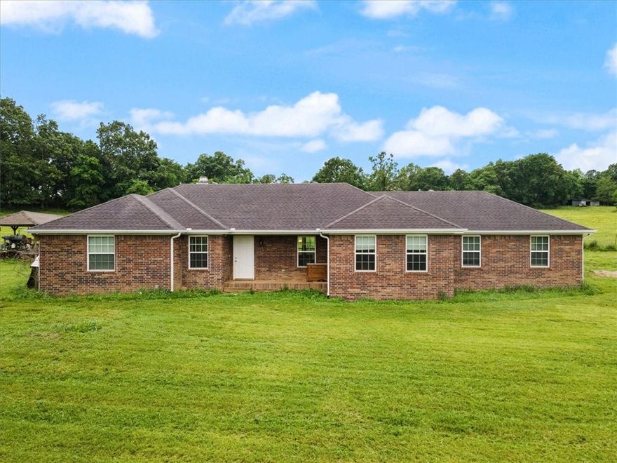 This cozy single-story all-brick home offers 4 bedrooms, 2 full bathrooms, and a spacious bonus room for flexible use. Nestled on Fayetteville's east side, this charming property sits off Cedar Bluff Rd. With 7 acres of pasture and hardwoods, with a history of cattle grazing. Convenience is key, with both Fayetteville and Springdale just a stone's throw away. Plus, Beaver Lake and a public boat ramp are mere minutes away, perfect for outdoor adventures. Additionally, on the south side of the property, an additional septic tank and rural water supply await, offering ample potential for future development, whether it be a new home or workshop. Don't let this rare opportunity slip through your fingers!