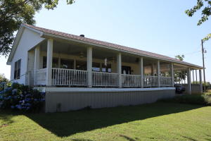 Country Paradise in small town Arkansas. This large 3 bed 2 bath home sits on 20 acres of land complete with a storm shelter, a 20X40 barn, 36X16 workshop, and tractor shed. Outside features beautiful landscaping, large trees, 2 ponds, and a large covered front porch perfect for sitting and enjoying the outdoors. Inside features a large living room, updated kitchen, and utility/sunroom. Also included is new windows, and new roof installed in 2017. Call today for your showing.