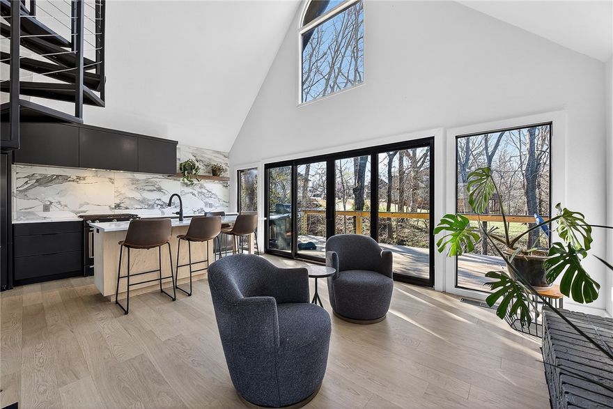 Rare and unique opportunity just steps from the Coler Mountain Bike Preserve South Gateway! Situated on nearly half an acre and only 200 yards from one of Bentonville’s most iconic trail systems, this fully updated home is a dream for investors, outdoor enthusiasts, or anyone wanting to live in the heart of the Mountain Bike Capital of the World. Completely renovated inside and out, updates include new cement siding, Pella windows and Pella 12 ft quad door with 6 ft opening, luxury vinyl plank flooring, and a stunning wrap-around deck overlooking a peaceful wooded setting. The kitchen features quartz countertops and premium KitchenAid appliances, while the spa-inspired bathroom showcases a Schluter shower system with heated floors in both the shower and bathroom. A custom spiral staircase adds a striking architectural element, and a tankless water heater provides modern efficiency. Priced well below recent appraised value, this property offers an exceptional opportunity!